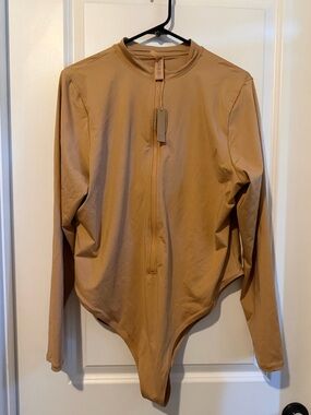 SKIMS Swim Zip Front Long Sleeve One Piece swimsuit.